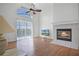 Bright living room with a fireplace and views of the pool at 7606 Fordham Creek Ln, Orlando, FL 32818