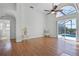 Bright living room with ceiling fan and sliding doors to the pool area at 7606 Fordham Creek Ln, Orlando, FL 32818