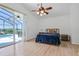 A spacious primary bedroom featuring light floors and a view of the pool area at 7606 Fordham Creek Ln, Orlando, FL 32818