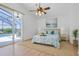 Bright bedroom with lanai access offers pool views and a tropical feel at 7606 Fordham Creek Ln, Orlando, FL 32818
