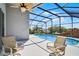 Screened-in pool with seating and a ceiling fan providing a relaxing outdoor space at 7606 Fordham Creek Ln, Orlando, FL 32818