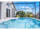 Sparkling blue swimming pool enclosed within a screened lanai, providing a private and refreshing retreat at 7606 Fordham Creek Ln, Orlando, FL 32818