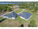 Aerial view of a large, modern home on a sprawling, grassy property with mature landscaping at 8003 Lake Nellie Rd, Clermont, FL 34714