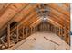 Spacious unfinished attic featuring exposed wooden beams and ample storage potential at 8003 Lake Nellie Rd, Clermont, FL 34714