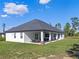 Large backyard featuring a covered patio, perfect for outdoor entertaining at 8003 Lake Nellie Rd, Clermont, FL 34714