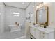 Bright bathroom featuring a freestanding tub, white cabinetry, gold fixtures, and shower at 8003 Lake Nellie Rd, Clermont, FL 34714