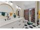 Contemporary bathroom featuring dual sinks, modern lighting, and stylish patterned floors at 8003 Lake Nellie Rd, Clermont, FL 34714