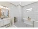 Luxurious bathroom featuring a soaking tub, gold accents, a large mirror, and white cabinetry at 8003 Lake Nellie Rd, Clermont, FL 34714