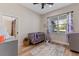 Bright Bedroom with a crib, calming decor, and a view of the outdoors at 8003 Lake Nellie Rd, Clermont, FL 34714