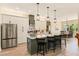 Spacious kitchen with island, white cabinets, stainless appliances, and open access to dining area at 8003 Lake Nellie Rd, Clermont, FL 34714