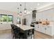 Modern kitchen with a large island, white cabinets, stainless steel appliances, and stylish pendant lighting at 8003 Lake Nellie Rd, Clermont, FL 34714