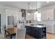 Bright kitchen with white cabinetry, an island with bar seating, and stainless steel appliances at 8003 Lake Nellie Rd, Clermont, FL 34714
