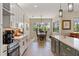 Bright kitchen flows into the dining area with natural light and modern appliances at 8003 Lake Nellie Rd, Clermont, FL 34714