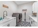 Well-equipped laundry room with modern appliances, black and white patterned flooring, and ample storage at 8003 Lake Nellie Rd, Clermont, FL 34714