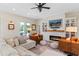 Comfortable living room features a fireplace, built-in bookshelves, and plush sectional seating at 8003 Lake Nellie Rd, Clermont, FL 34714