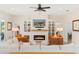 Bright living room with modern fireplace, built-in shelving, and comfortable seating arrangement at 8003 Lake Nellie Rd, Clermont, FL 34714