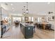 Open-concept floorplan features kitchen island, dining area, and living space with ample natural light at 8003 Lake Nellie Rd, Clermont, FL 34714