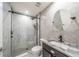 Modern bathroom with a glass-enclosed shower, decorative tile, and sleek vanity at 828 Gisele Ct, Haines City, FL 33844
