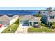 Aerial view of a lovely home near a lake, featuring well-manicured landscaping and a private driveway at 828 Gisele Ct, Haines City, FL 33844