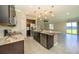Open-concept kitchen with a large island, stainless steel appliances, and a seamless view of the lake at 828 Gisele Ct, Haines City, FL 33844