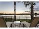 Backyard with lounge chairs and lake views at sunset; enjoy relaxation and scenery at 834 Golden Bear Dr, Reunion, FL 34747