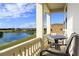 Balcony featuring outdoor seating and scenic views of the lake and neighboring homes at 834 Golden Bear Dr, Reunion, FL 34747