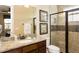 Well-appointed bathroom featuring a granite countertop vanity, glass-enclosed shower, and modern fixtures at 834 Golden Bear Dr, Reunion, FL 34747