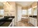Bathroom featuring granite counters, tile floors, soaking tub, and neutral decor at 834 Golden Bear Dr, Reunion, FL 34747