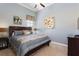 Comfortable bedroom with calm blue tones, featuring a queen bed, ceiling fan and soft natural light at 834 Golden Bear Dr, Reunion, FL 34747