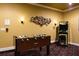 Entertainment room includes a foosball table and arcade game, perfect for Gathering fun and leisure at 834 Golden Bear Dr, Reunion, FL 34747