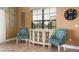 Cozy living room featuring a decorative console table and matching patterned chairs, illuminated by natural light from the window at 834 Golden Bear Dr, Reunion, FL 34747