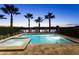 Backyard pool area featuring a spa, palm trees, and well-maintained landscaping at 834 Golden Bear Dr, Reunion, FL 34747