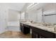 Bathroom features granite countertops, dual sinks, soaking tub, and separate shower at 838 Kildrummy Dr, Davenport, FL 33896