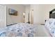 Spacious bedroom featuring a decorative bed spread, a TV, and a view into a hallway at 838 Kildrummy Dr, Davenport, FL 33896