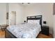 Bright bedroom with ceiling fan, wood floors, black bed frame, and a decorative bed spread at 838 Kildrummy Dr, Davenport, FL 33896