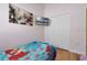bedroom with wooden floors, twin bed, mounted TV, and closet at 838 Kildrummy Dr, Davenport, FL 33896