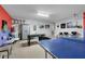 Spacious game room featuring ping pong table, foosball, seating, and eclectic decor at 838 Kildrummy Dr, Davenport, FL 33896