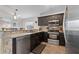 Updated kitchen showcasing stainless steel appliances and dark wood cabinetry at 838 Kildrummy Dr, Davenport, FL 33896