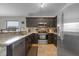 Kitchen featuring stainless steel appliances, dark cabinets, and granite countertops at 838 Kildrummy Dr, Davenport, FL 33896
