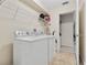 Laundry room with a washing machine, dryer, shelves and view into a closet at 838 Kildrummy Dr, Davenport, FL 33896