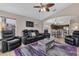 Open-concept living room featuring kitchen view, tv, modern console, and black leather seating at 838 Kildrummy Dr, Davenport, FL 33896