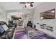 Open living room with archway to dining area, tv, modern console, and black leather seating at 838 Kildrummy Dr, Davenport, FL 33896