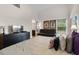 Main bedroom featuring a sitting area, ensuite bath access, and modern decor at 838 Kildrummy Dr, Davenport, FL 33896