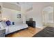 Bedroom featuring hardwood floors, a couch, and ensuite bathroom access at 838 Kildrummy Dr, Davenport, FL 33896
