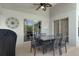 Covered patio area with ceiling fan, outdoor dining set, and view to pool area at 838 Kildrummy Dr, Davenport, FL 33896