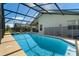 Sparkling enclosed pool area surrounded by lush landscaping, patio seating, and privacy fence at 838 Kildrummy Dr, Davenport, FL 33896