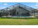 Relax in this screened-in backyard pool with a chair to enjoy the outside atmosphere at 838 Kildrummy Dr, Davenport, FL 33896