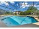 Enclosed pool area featuring slide and beautiful blue water at 838 Kildrummy Dr, Davenport, FL 33896