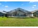 Enjoy a refreshing swim in this screened-in backyard pool surrounded by lush green grass at 838 Kildrummy Dr, Davenport, FL 33896