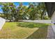 Spacious backyard featuring a well-maintained lawn, mature trees, and a white privacy fence at 843 W Swoope Ave, Winter Park, FL 32789